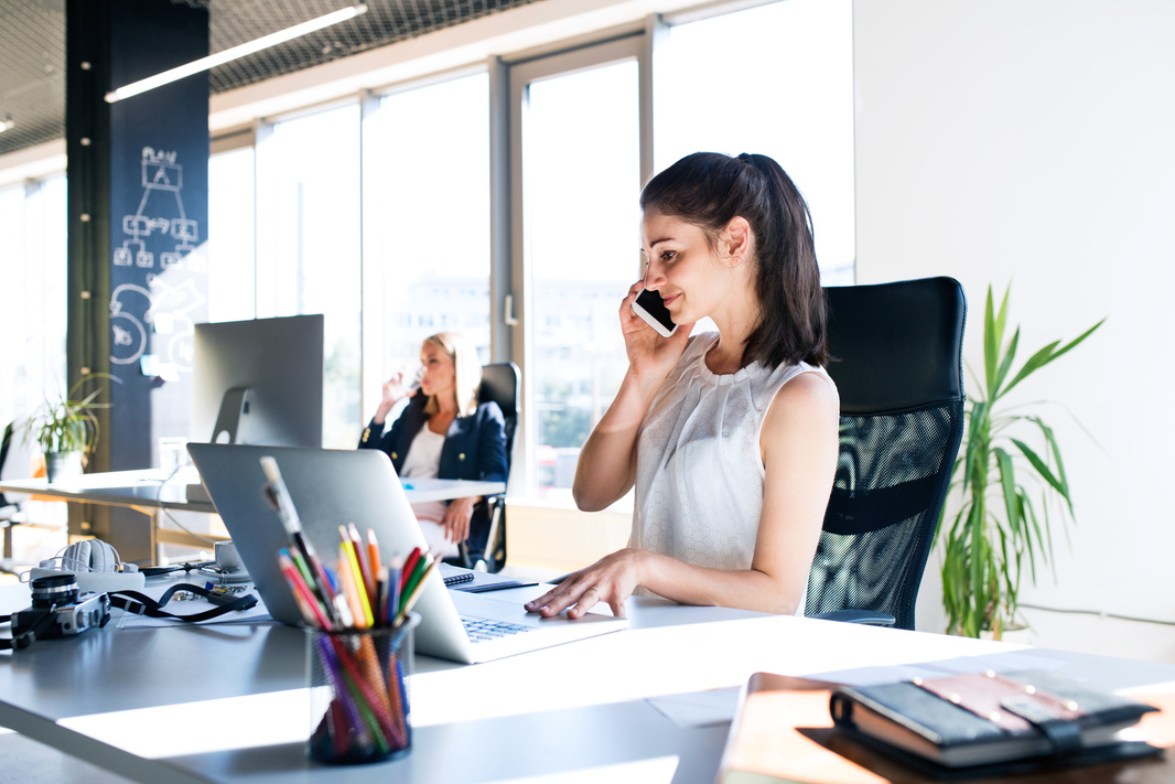 Two Business Women in the Office Working